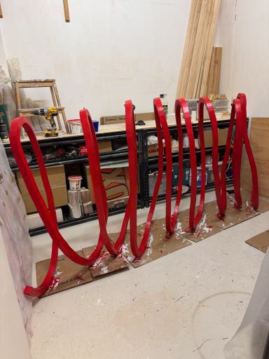 A physical form study of the looping sculpture profile, standing in the Trade Arts workshop