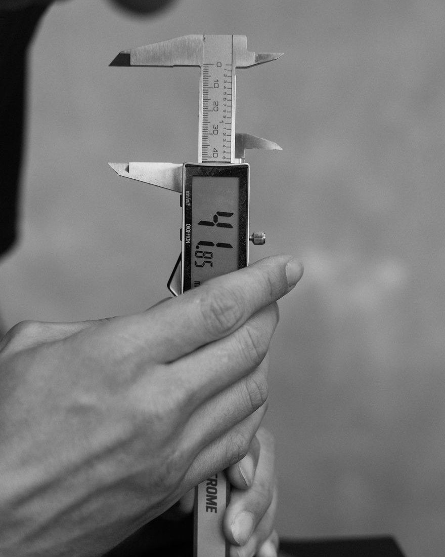 Digital vernier callipers measuring a component in the workshop